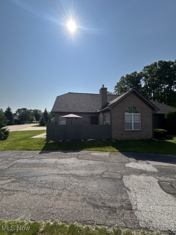 8050 Harbor Creek Dr Unit 1903, Mentor-On-The-Lake, OH 44060 - view of front of house with brick siding, a chimney, and roof with shingles
