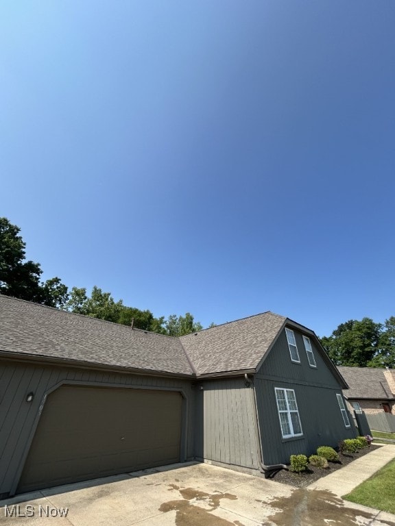 8050 Harbor Creek Dr Unit 1903, Mentor-On-The-Lake, OH 44060 - view of property exterior with an attached garage, driveway, and a shingled roof