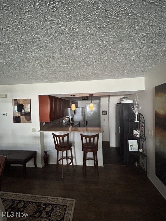 8050 Harbor Creek Dr Unit 1903, Mentor-On-The-Lake, OH 44060 - dining area featuring a textured ceiling and dark wood finished floors