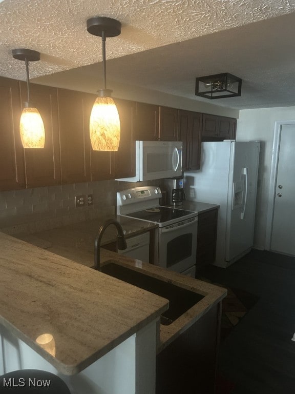 8050 Harbor Creek Dr Unit 1903, Mentor-On-The-Lake, OH 44060 - kitchen with white appliances, hanging light fixtures, a textured ceiling, and a peninsula