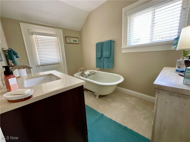 904 Chalker St, Akron, OH 44310 - full bathroom featuring vaulted ceiling, a freestanding tub, and double vanity