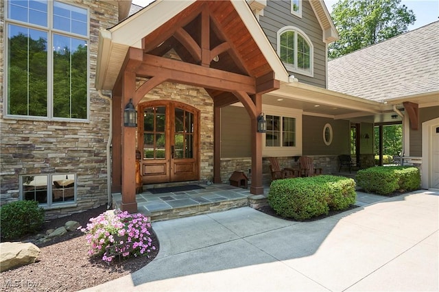 3116 Aviemore Way, Richfield, OH 44286 - property entrance featuring stone siding, a shingled roof, and a porch