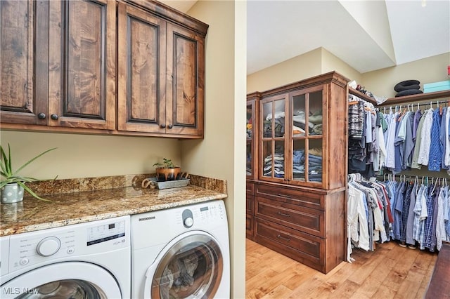 3116 Aviemore Way, Richfield, OH 44286 - laundry room with washing machine and clothes dryer, cabinet space, and light wood-style flooring