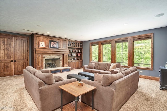 3116 Aviemore Way, Richfield, OH 44286 - living room featuring light colored carpet, recessed lighting, and a stone fireplace