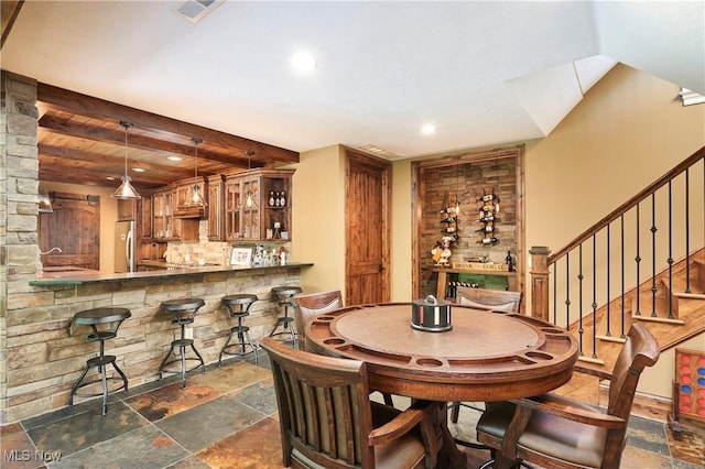3116 Aviemore Way, Richfield, OH 44286 - dining space featuring bar, dark stone finish floors, recessed lighting, and stairway