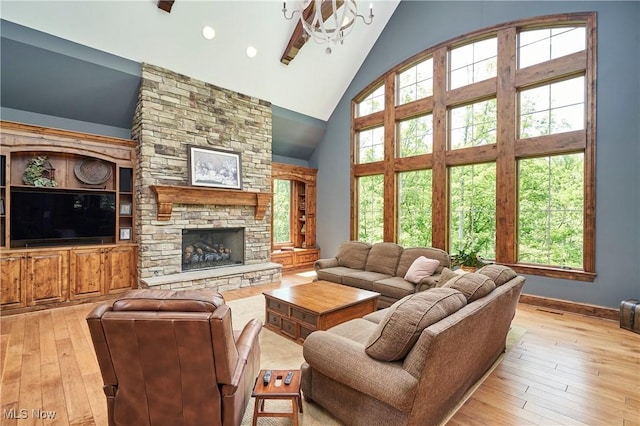 3116 Aviemore Way, Richfield, OH 44286 - living area featuring high vaulted ceiling, light wood-style flooring, healthy amount of natural light, and a stone fireplace