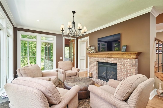 3116 Aviemore Way, Richfield, OH 44286 - living room with wood finished floors, a chandelier, ornamental molding, a brick fireplace, and recessed lighting