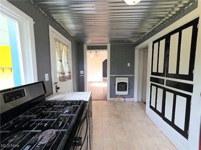 10 Browns Ridge Rd, Rockport, WV 26169 - kitchen with stainless steel range with gas stovetop, heating unit, and light wood-style flooring