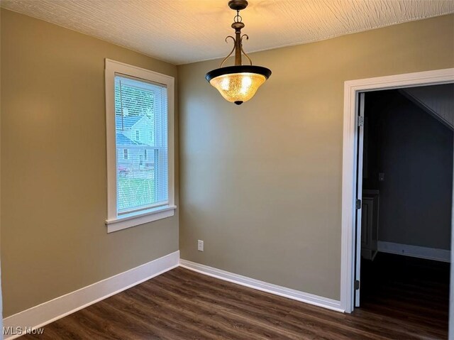 307 Lucas St, Barberton, OH 44203 - spare room featuring dark wood-type flooring and baseboards