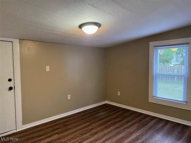 307 Lucas St, Barberton, OH 44203 - unfurnished room with dark wood-type flooring and a textured ceiling