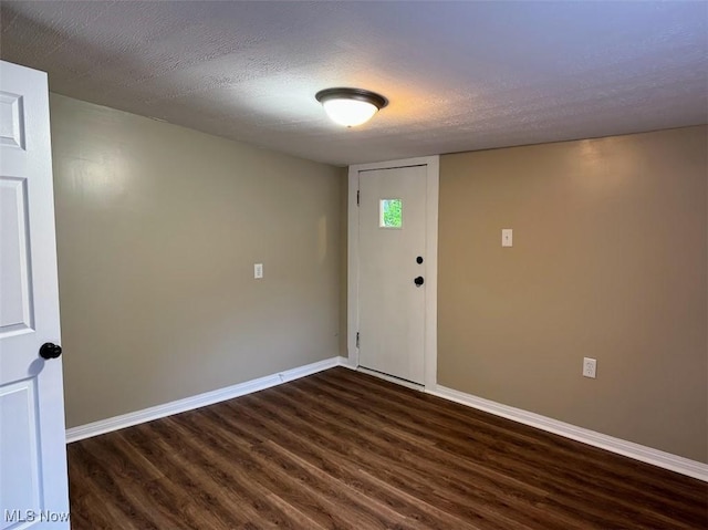 307 Lucas St, Barberton, OH 44203 - unfurnished room featuring dark wood-type flooring and a textured ceiling