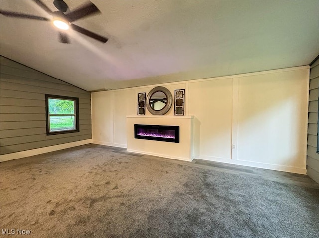 1121 Old Rosemar Rd, Parkersburg, WV 26104 - unfurnished living room featuring vaulted ceiling, carpet, a glass covered fireplace, and ceiling fan