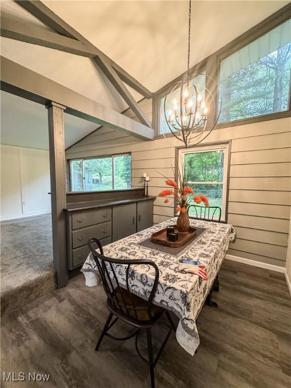 1121 Old Rosemar Rd, Parkersburg, WV 26104 - dining space featuring a chandelier, lofted ceiling, dark wood-style floors, and wood walls