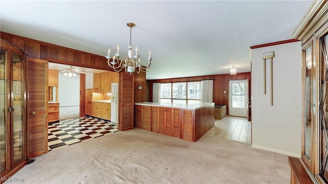 7780 Clarion Dr, Chagrin Falls, OH 44022 - kitchen with a chandelier, a peninsula, light countertops, wooden walls, and light colored carpet