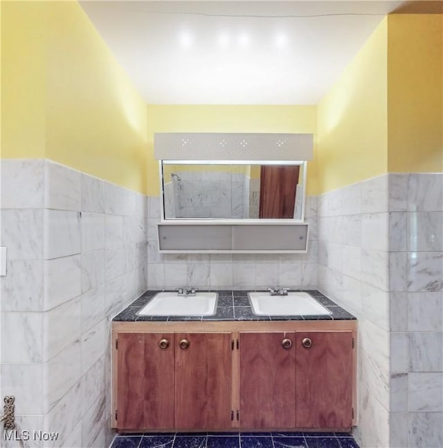 7780 Clarion Dr, Chagrin Falls, OH 44022 - bathroom featuring tile walls, double vanity, and wainscoting