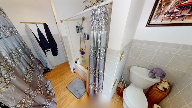 217 Meadowbrook Ave, Boardman, OH 44512 - bathroom featuring tile walls, wood finished floors, wainscoting, and shower / tub combo