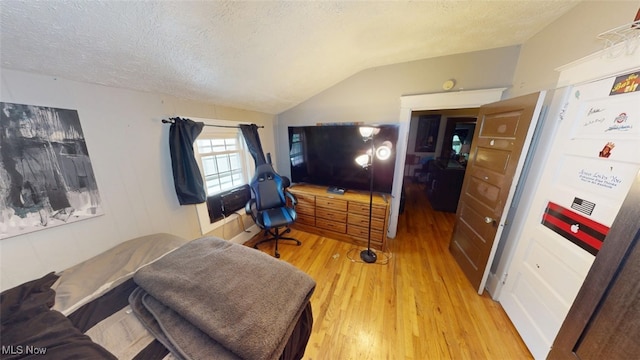 217 Meadowbrook Ave, Boardman, OH 44512 - bedroom featuring vaulted ceiling, a textured ceiling, and light wood-type flooring
