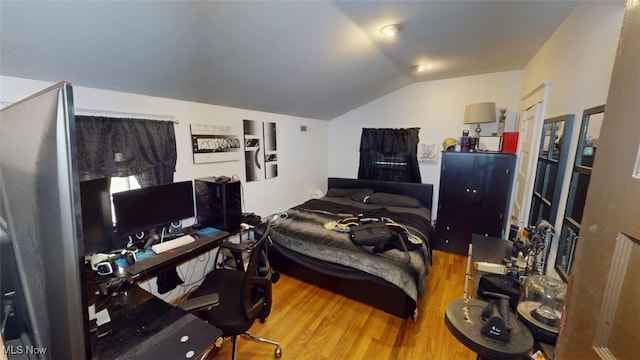 217 Meadowbrook Ave, Boardman, OH 44512 - bedroom with wood finished floors, vaulted ceiling, and an office area