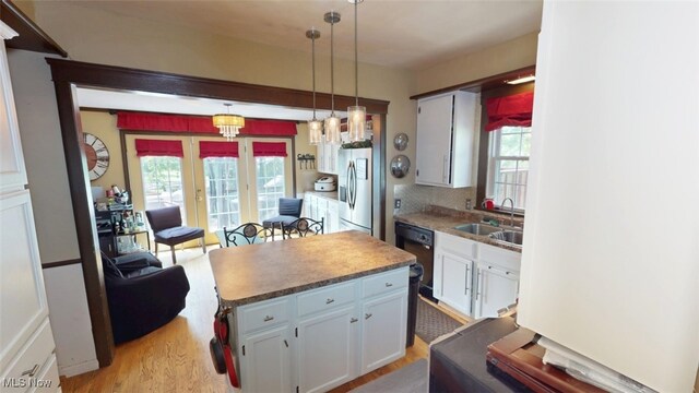 217 Meadowbrook Ave, Boardman, OH 44512 - kitchen featuring stainless steel fridge, dishwasher, light wood-type flooring, and plenty of natural light