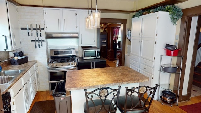 217 Meadowbrook Ave, Boardman, OH 44512 - kitchen with appliances with stainless steel finishes, light wood-style floors, light countertops, and white cabinetry
