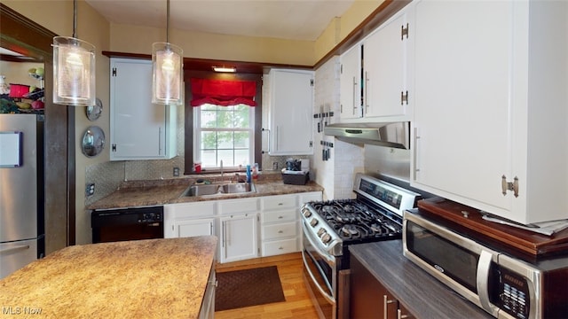 217 Meadowbrook Ave, Boardman, OH 44512 - kitchen featuring appliances with stainless steel finishes, under cabinet range hood, decorative backsplash, and white cabinets