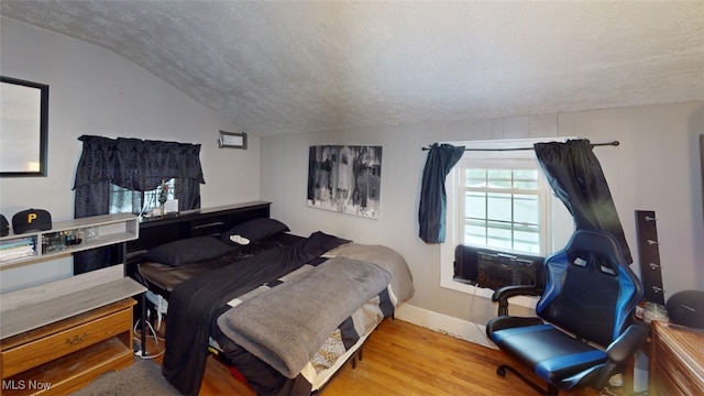 217 Meadowbrook Ave, Boardman, OH 44512 - bedroom with vaulted ceiling, wood finished floors, a textured ceiling, and cooling unit