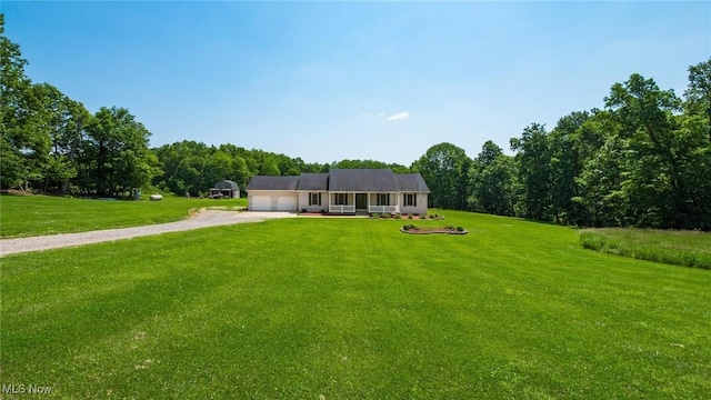 9910 Matchett Rd, Norwich, OH 43767 - view of front facade with driveway, an attached garage, and a front lawn
