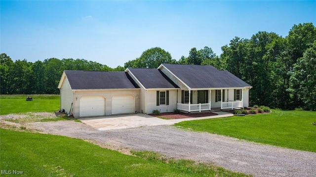 9910 Matchett Rd, Norwich, OH 43767 - ranch-style house featuring covered porch, a garage, driveway, and a front yard