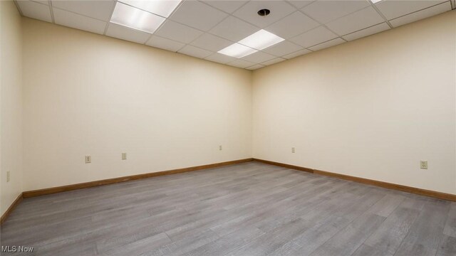 9910 Matchett Rd, Norwich, OH 43767 - empty room with light wood finished floors and a drop ceiling