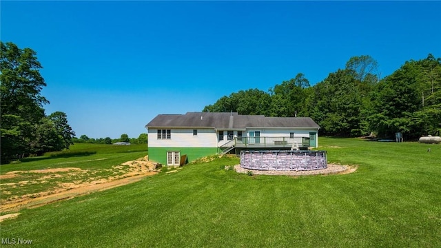 9910 Matchett Rd, Norwich, OH 43767 - rear view of house featuring a deck and a lawn