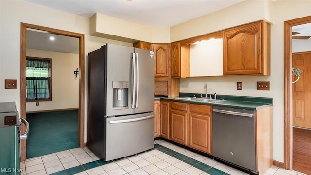 9910 Matchett Rd, Norwich, OH 43767 - kitchen featuring appliances with stainless steel finishes, brown cabinetry, dark countertops, and light tile patterned floors