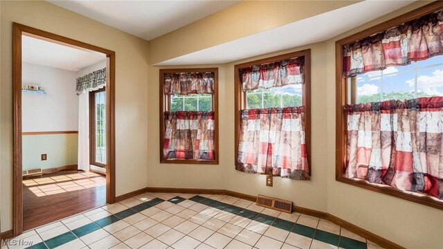 9910 Matchett Rd, Norwich, OH 43767 - empty room with light tile patterned floors and baseboards