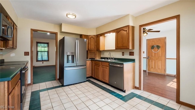 9910 Matchett Rd, Norwich, OH 43767 - kitchen with appliances with stainless steel finishes, light tile patterned flooring, brown cabinets, and dark countertops