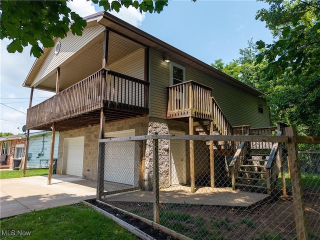 1104 4th St, Belpre, OH 45714 - rear view of property with an attached garage, concrete driveway, and stairs