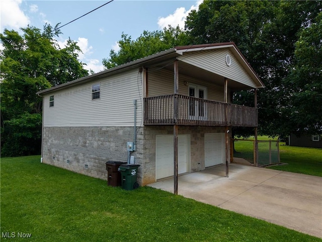 1104 4th St, Belpre, OH 45714 - view of property exterior featuring a garage, a yard, driveway, and a balcony