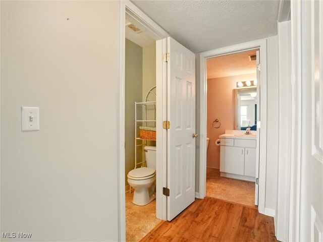 5237 Lake Rd W Unit 1133, Ashtabula, OH 44004 - hallway with light wood-style flooring and a textured ceiling