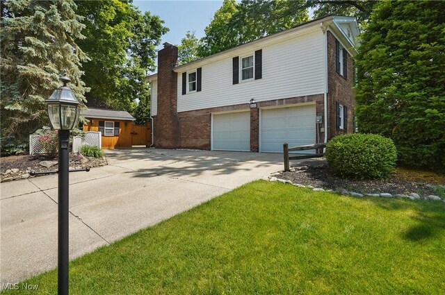 240 S Park Dr, Aurora, OH 44202 - view of front of property featuring brick siding, driveway, a chimney, a garage, and a front lawn