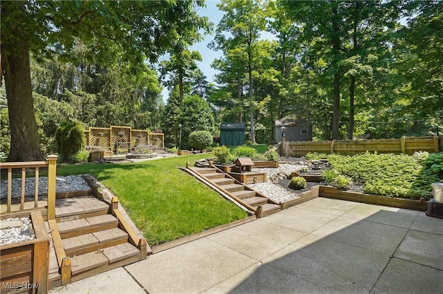 240 S Park Dr, Aurora, OH 44202 - view of yard with a patio area, a storage unit, view of wooded area, and a vegetable garden