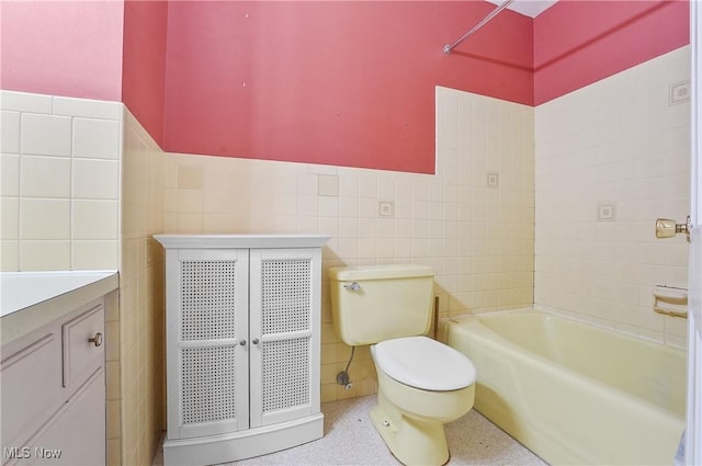 240 S Park Dr, Aurora, OH 44202 - full bath featuring tile walls, a tub, vanity, and wainscoting