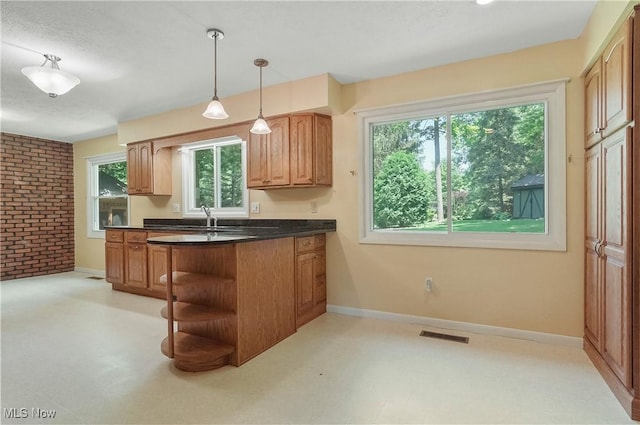 240 S Park Dr, Aurora, OH 44202 - kitchen featuring brick wall, dark countertops, healthy amount of natural light, open shelves, and hanging light fixtures
