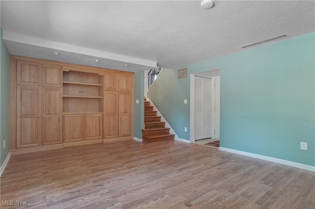 240 S Park Dr, Aurora, OH 44202 - unfurnished living room featuring light wood-style flooring and stairway