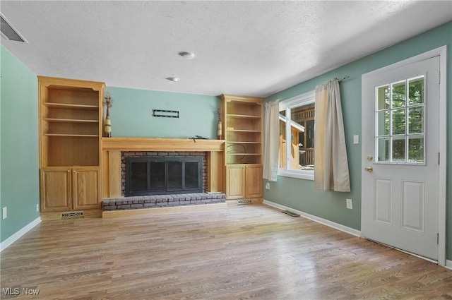 240 S Park Dr, Aurora, OH 44202 - unfurnished living room featuring wood finished floors, a textured ceiling, and a fireplace