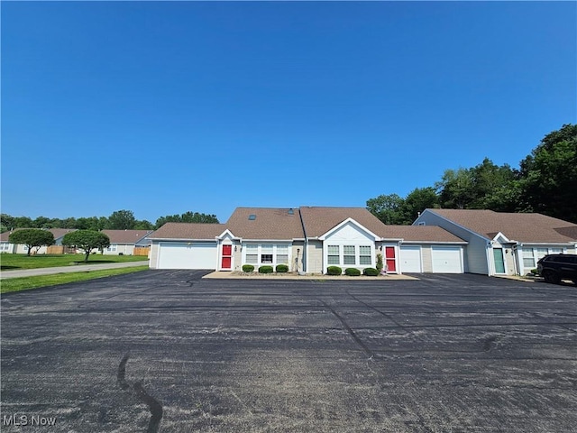 3308 Trappers Trl Unit A, Cortland, OH 44410 - view of front of property with asphalt driveway and a garage