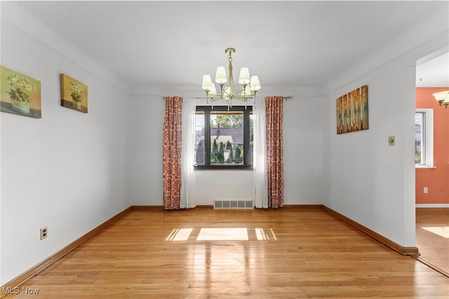 2637 Carmen Dr, Rocky River, OH 44116 - unfurnished dining area featuring a chandelier, plenty of natural light, and light wood finished floors