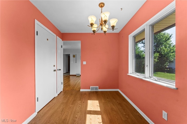 2637 Carmen Dr, Rocky River, OH 44116 - unfurnished dining area with a chandelier and wood finished floors
