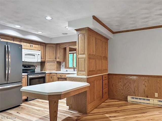 1027 Twp Rd Unit 1806, Ashland, OH 44805 - kitchen featuring appliances with stainless steel finishes, a wainscoted wall, light wood-type flooring, light countertops, and ornamental molding