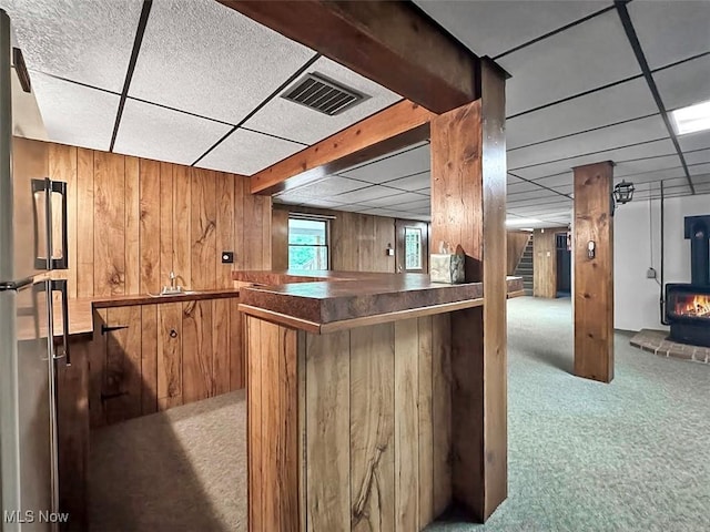 1027 Twp Rd Unit 1806, Ashland, OH 44805 - indoor bar featuring carpet floors, high quality fridge, a wood stove, a drop ceiling, and wooden walls