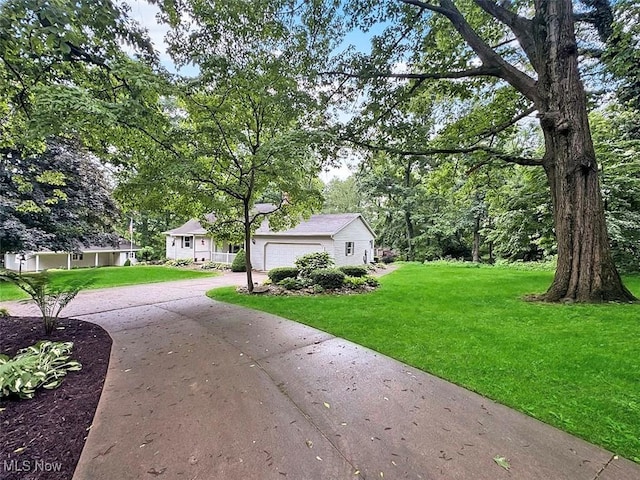 1027 Twp Rd Unit 1806, Ashland, OH 44805 - view of green lawn featuring driveway and an attached garage