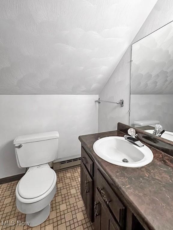 1027 Twp Rd Unit 1806, Ashland, OH 44805 - half bath with a baseboard radiator, vanity, lofted ceiling, and tile patterned floors