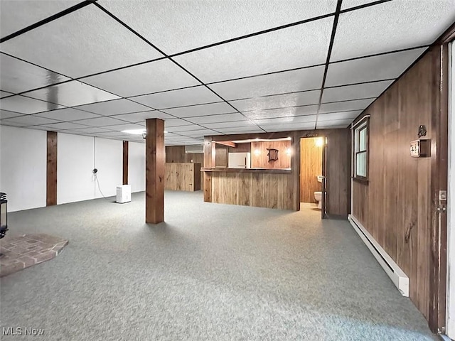 1027 Twp Rd Unit 1806, Ashland, OH 44805 - finished basement with baseboard heating, wooden walls, bar, fridge, and a paneled ceiling